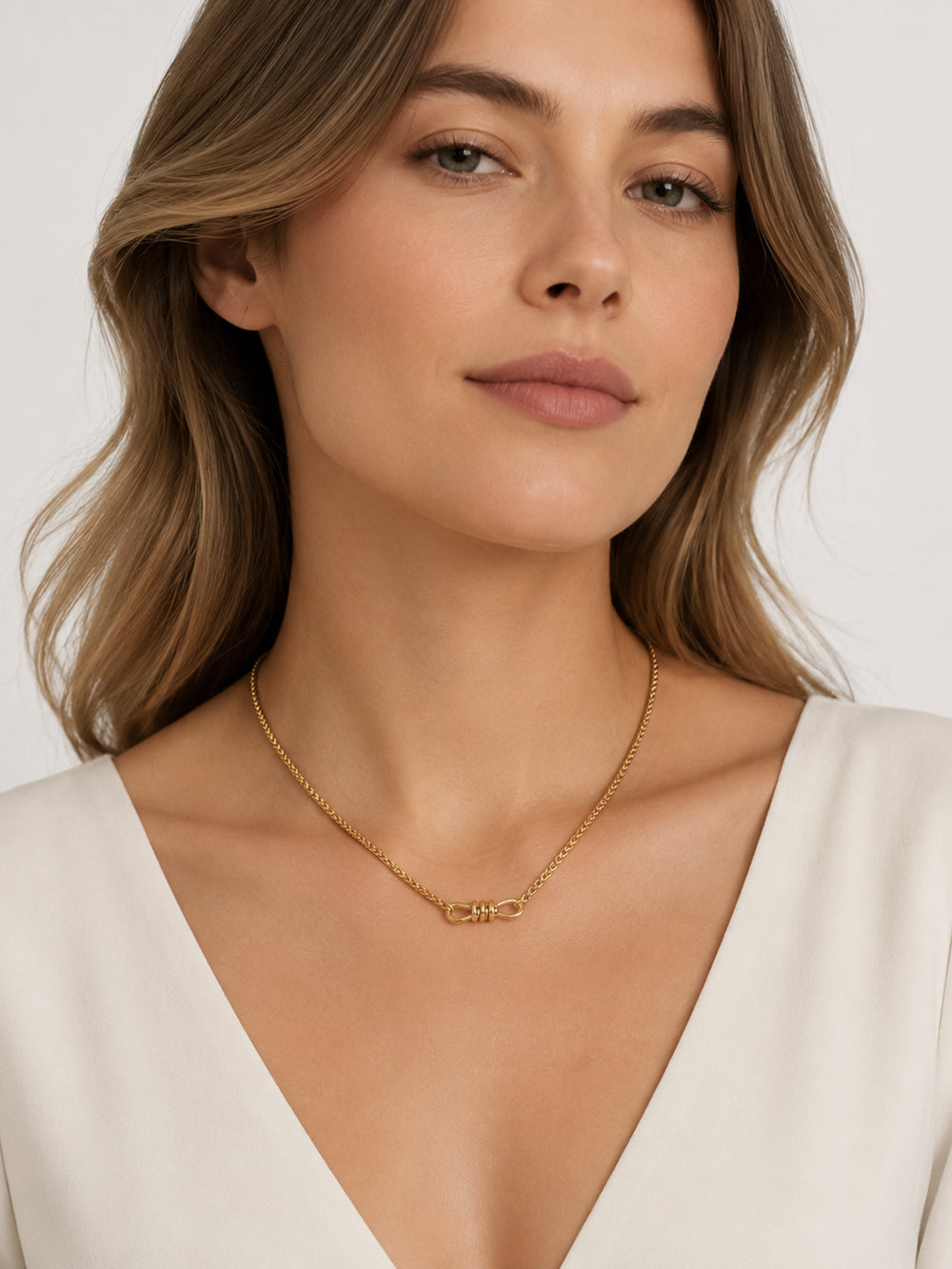 Aella gold knot necklace styled on model