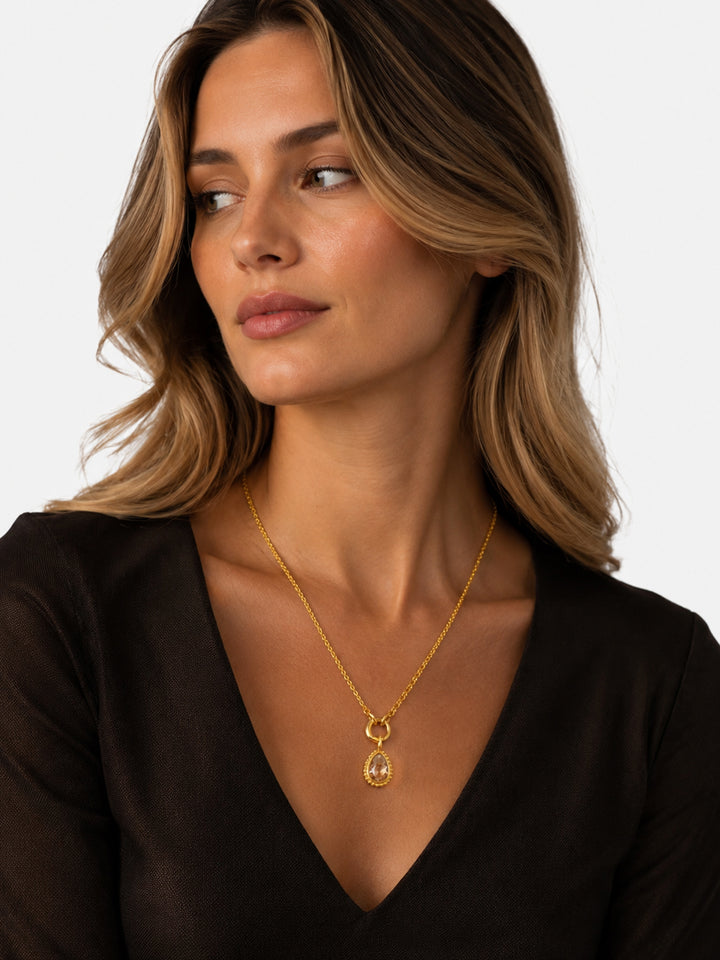 Amber teardrop gold necklace styled on model