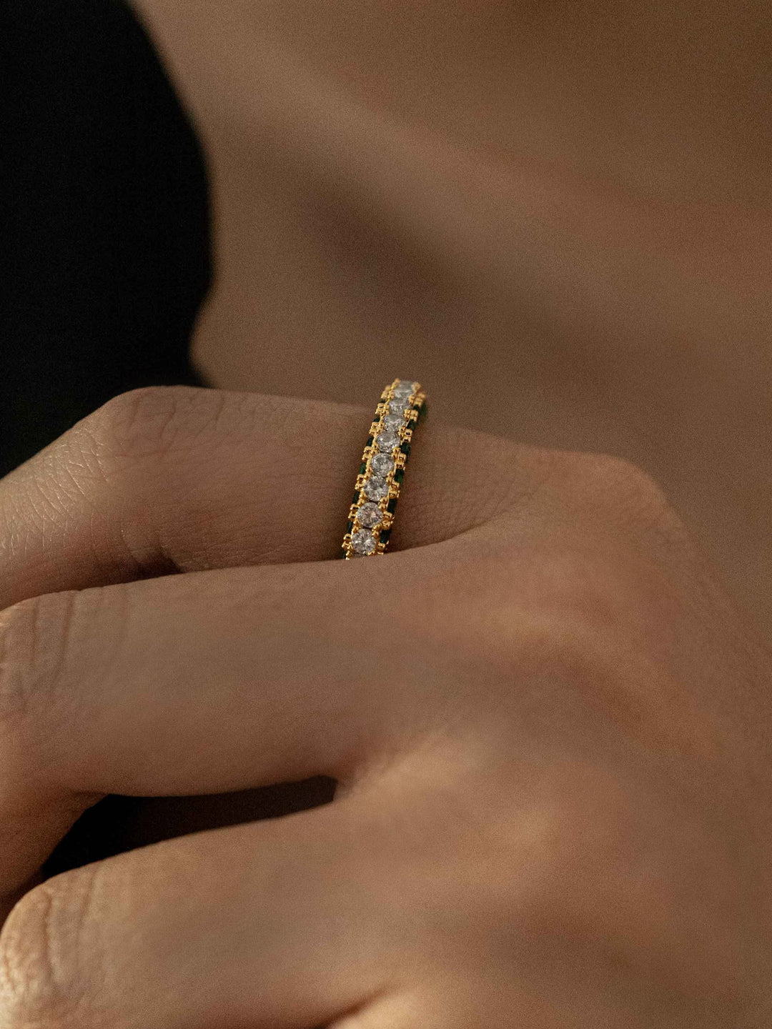 a hand wear A ring with two colors of zirconia.