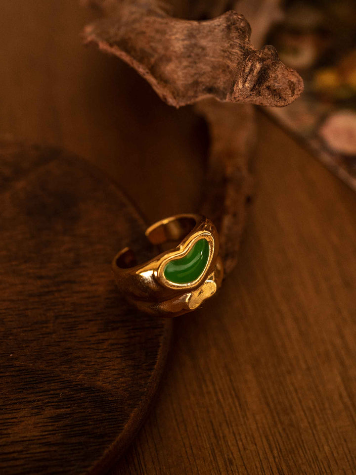 A gold ring with love hearts in cold enamel