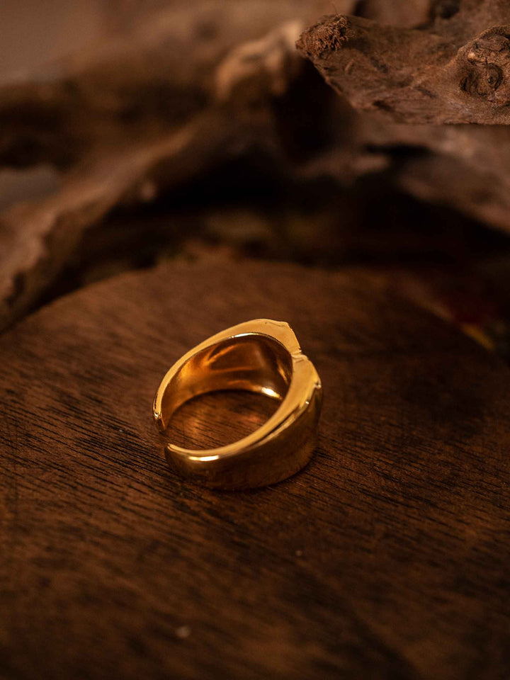 A gold ring with love hearts in cold enamel