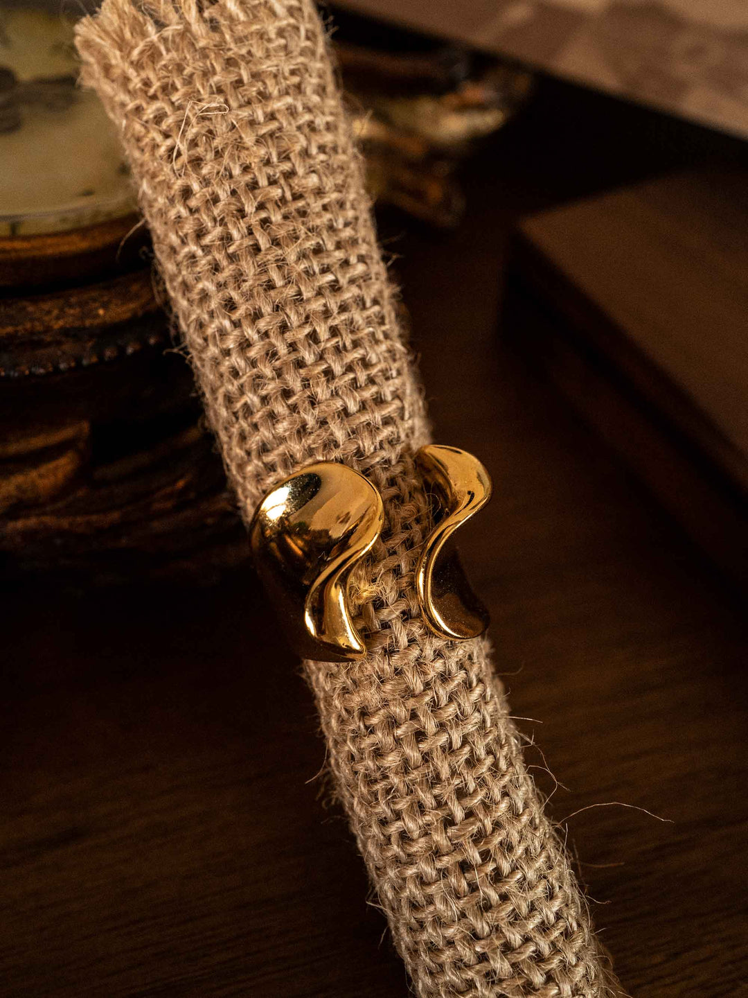 A gold ring in the shape of a sea wave