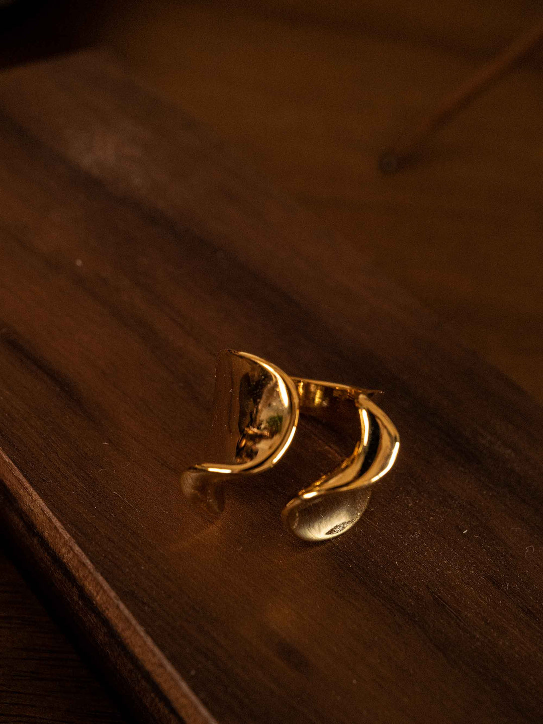 A gold ring in the shape of a sea wave