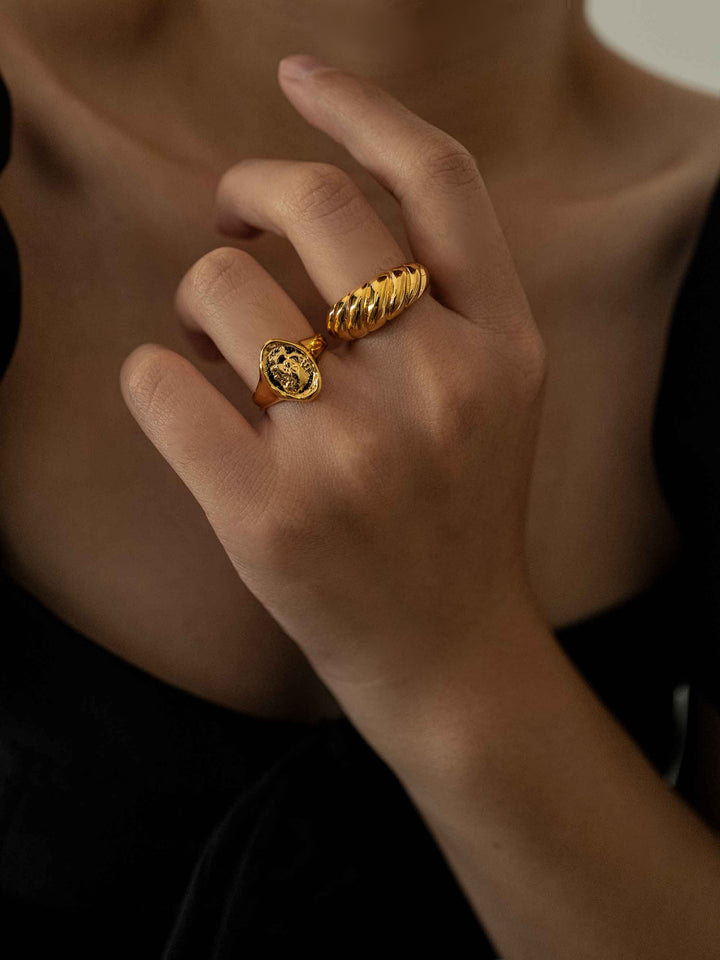 a hand wear A gold ring in the shape of a twist