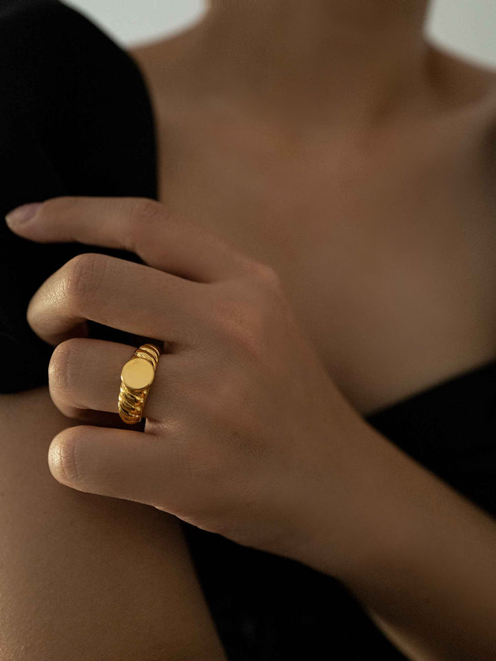 A gold ring with a spiral pattern