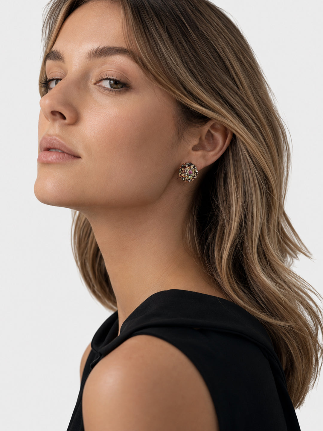 Multicolor crystal stud earrings worn with black outfit