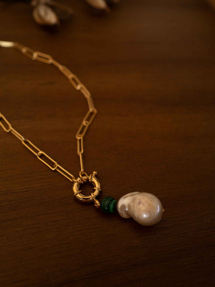 A gold necklace with baroque pearls and malachite