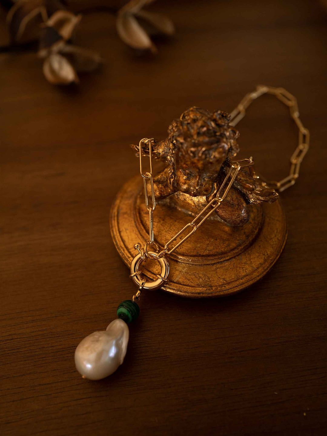 A gold necklace with baroque pearls and malachite