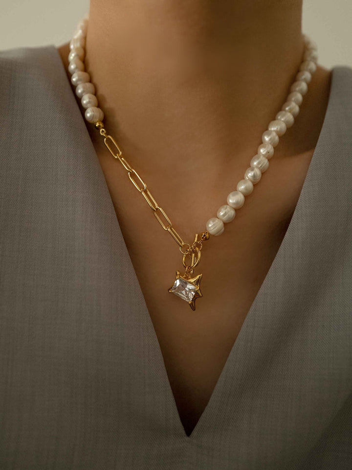 a model wear A pearl necklace with square zirconia