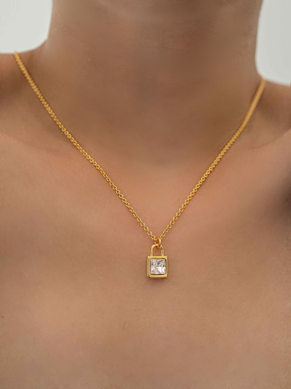 a model wear One locket glass crystal pendant gold necklace