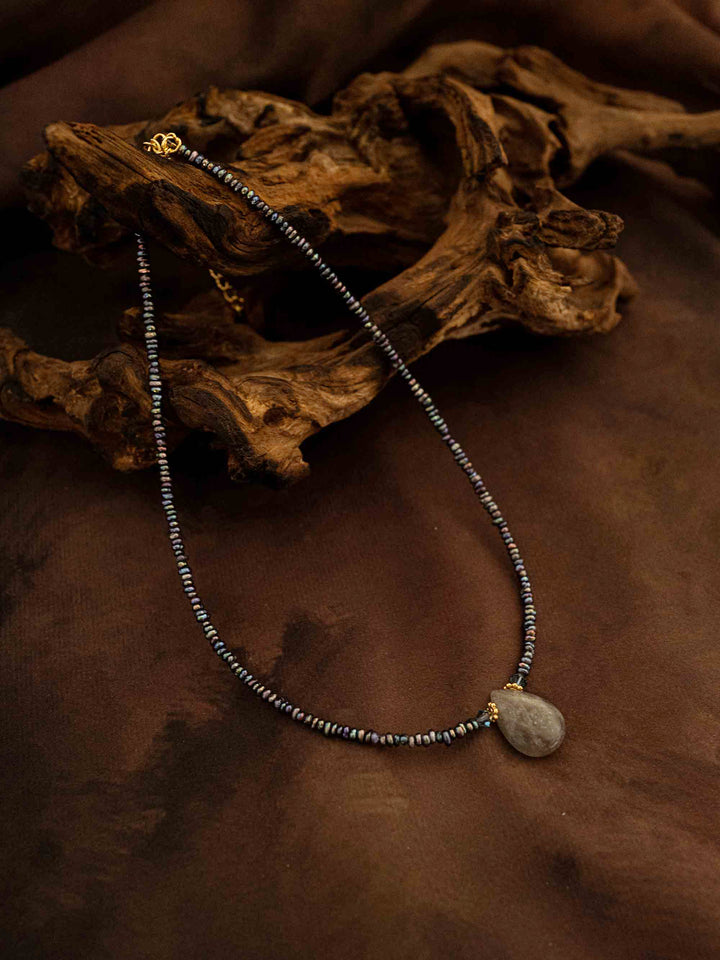 A necklace handmade from abalone shells and natural stones