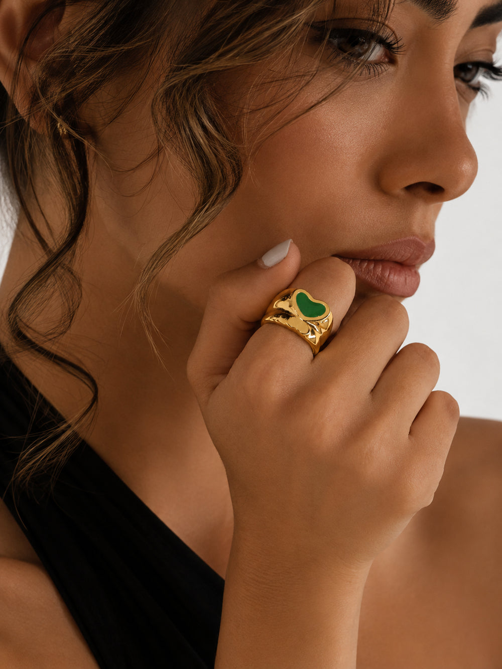 Edeline green heart ring styled on hand