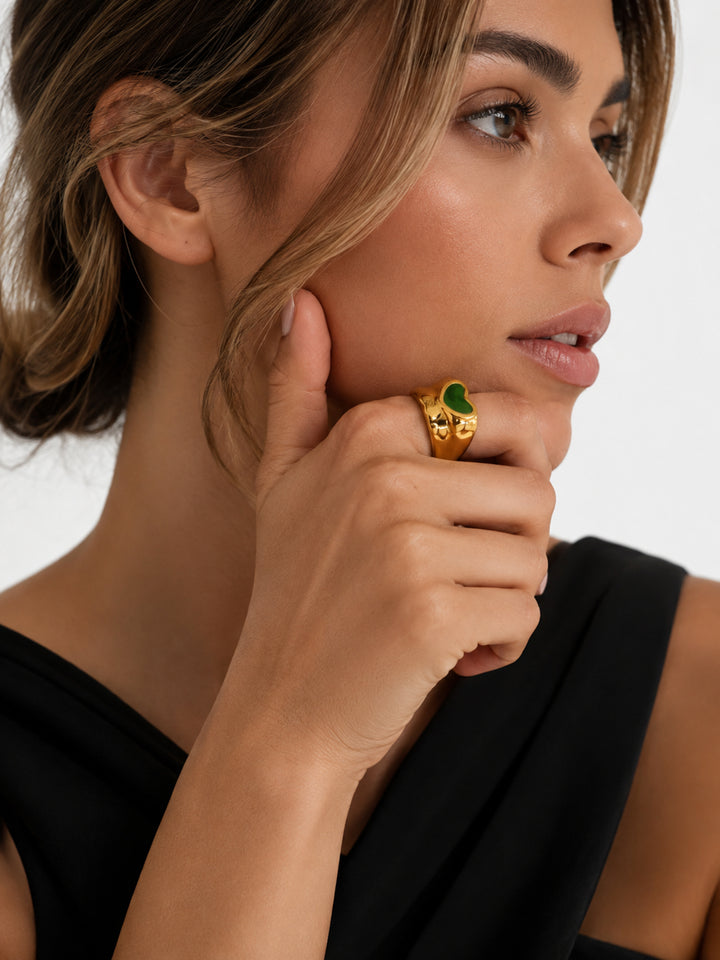 Gold-plated heart ring worn with black outfit