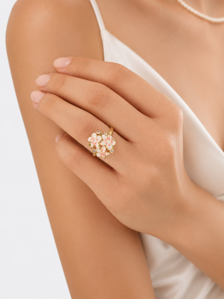 Gold-plated enamel flower ring worn with white outfit