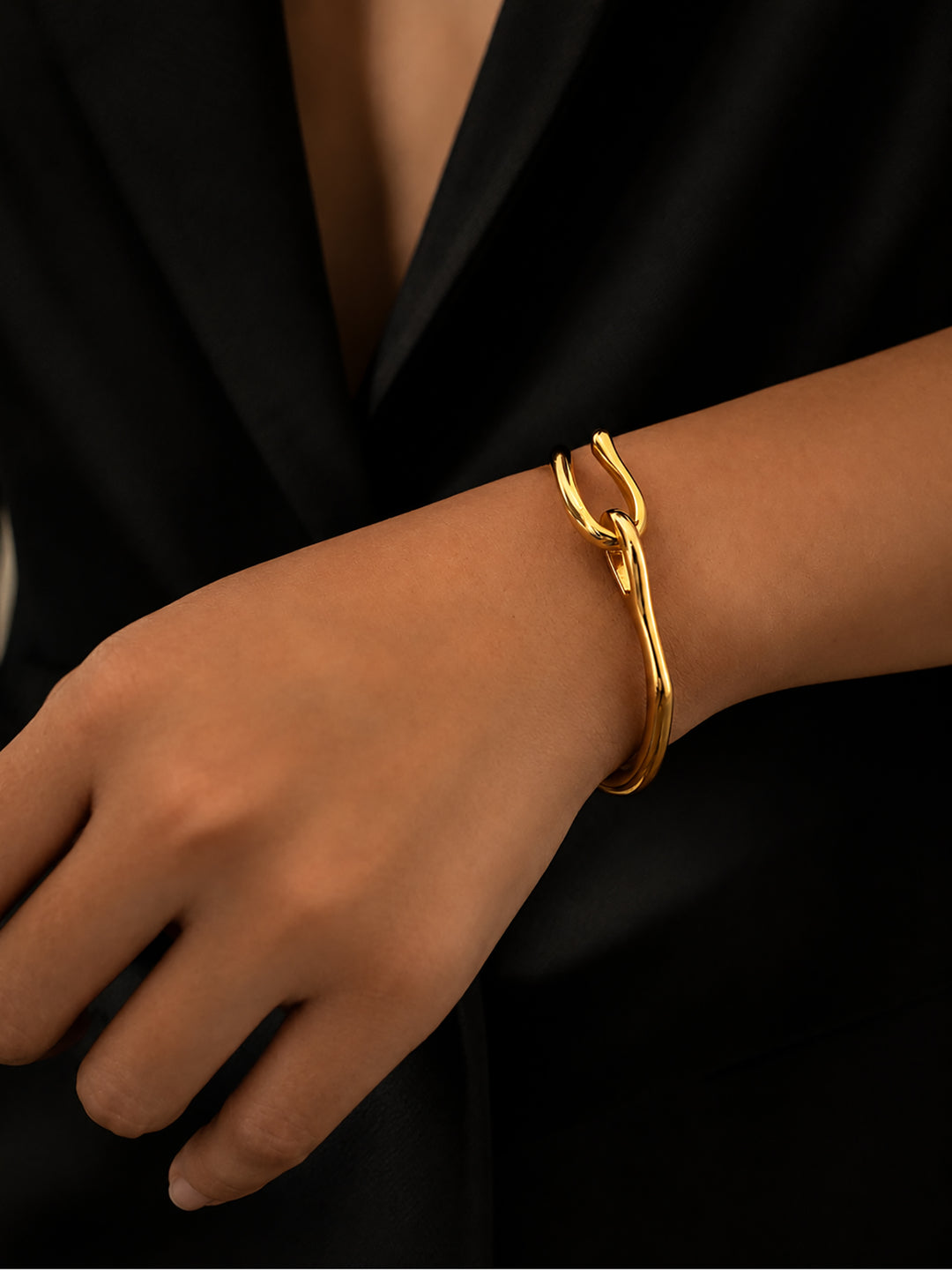Gold-plated hook bracelet worn with black outfit