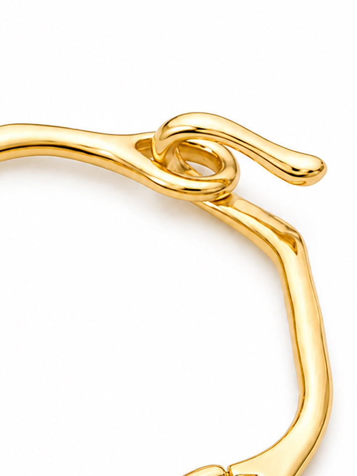 Sculptural hinged bracelet with hook closure detail