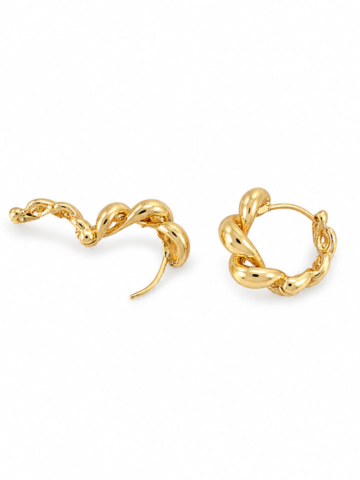 Gold-plated hoop earrings on red satin