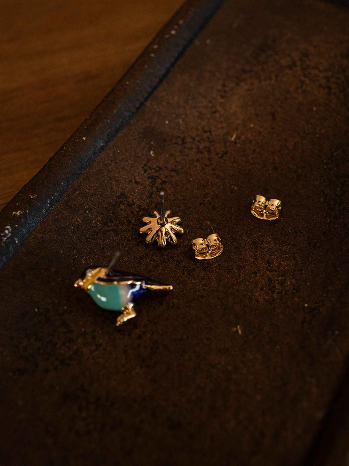A bird and flower set of earrings