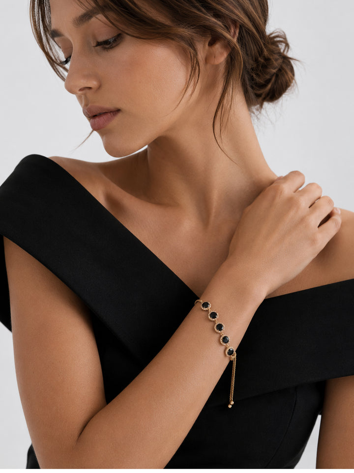 Adjustable black crystal bracelet worn with black outfit