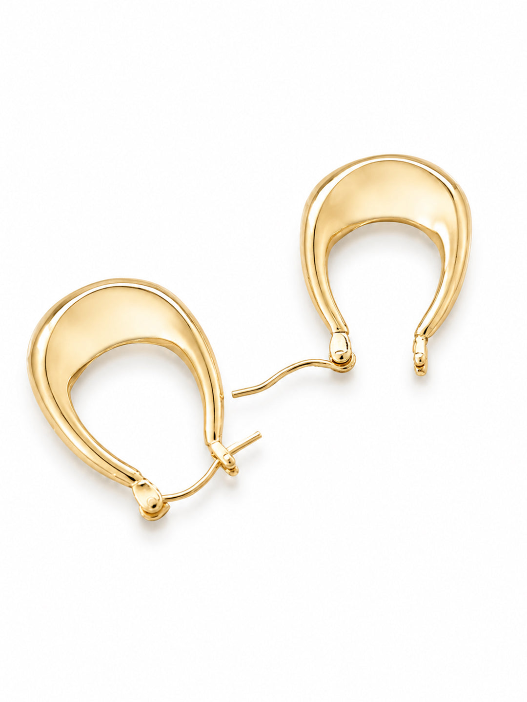 Gold-plated sculptural hoop earrings worn close to the ear