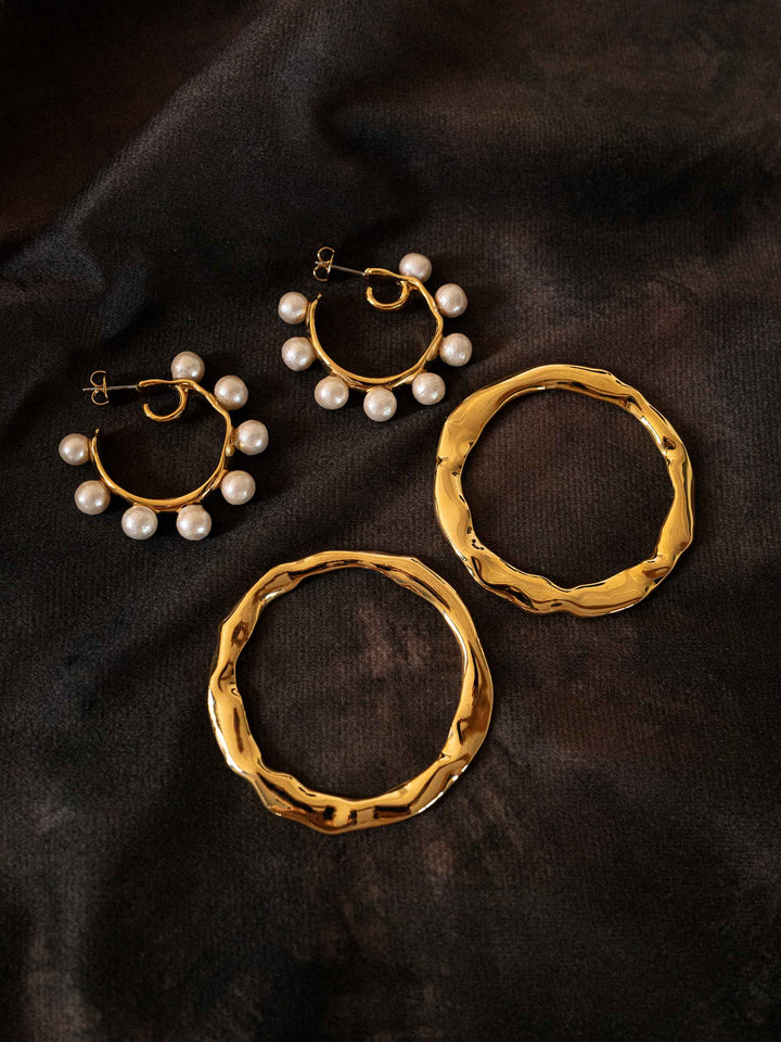 A gold hoop earring that can be worn as a detachable piece.