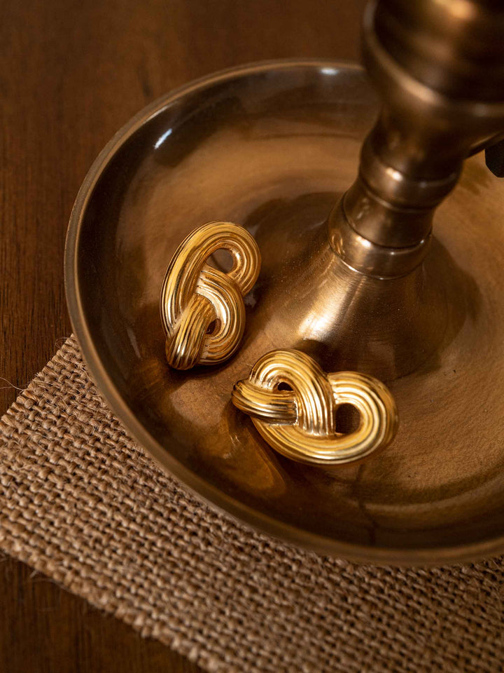 A pair of gold heart earrings