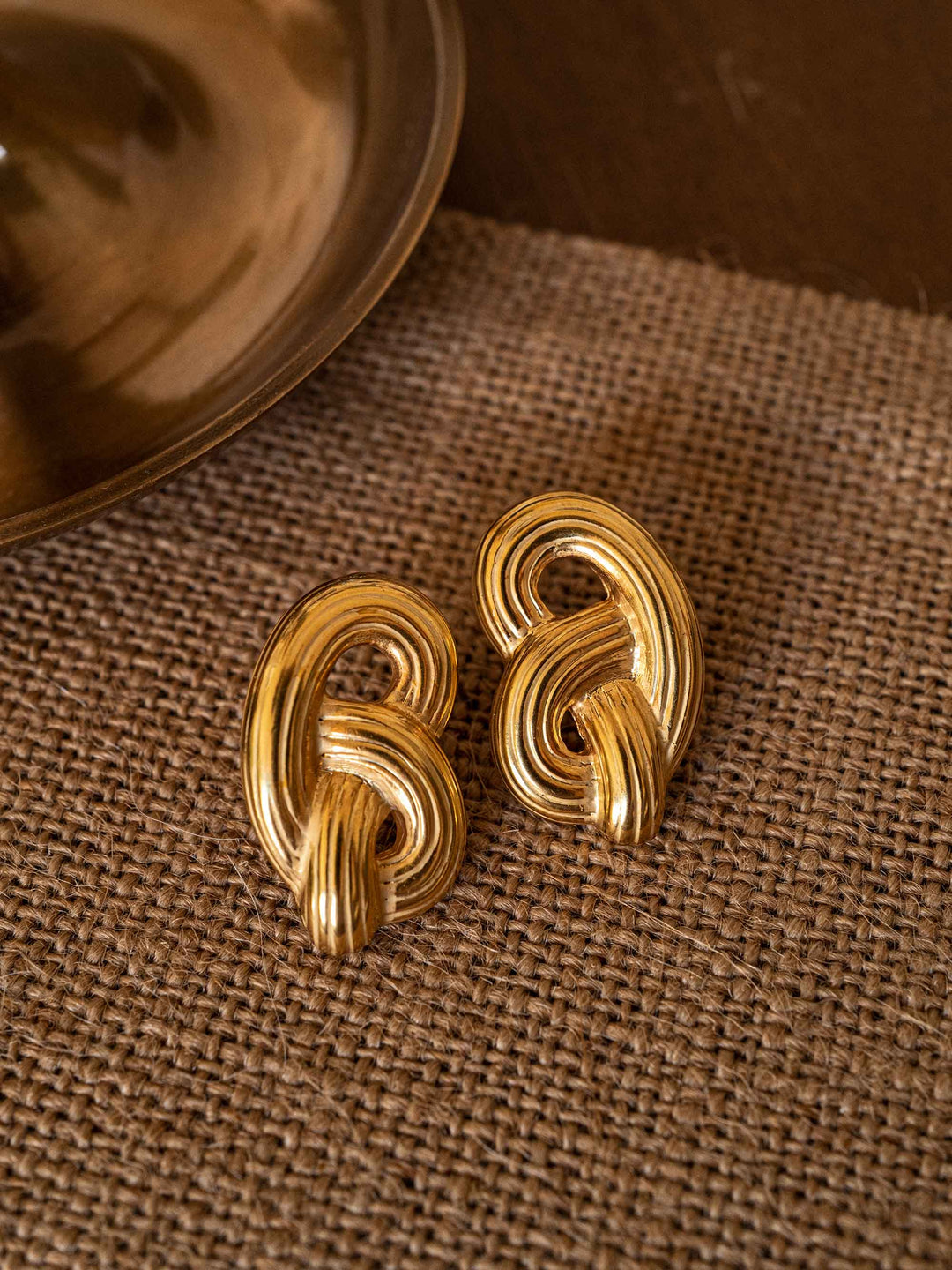 A pair of gold heart earrings
