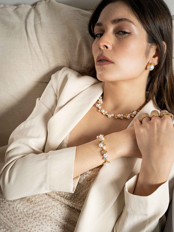 model wears Golden pearl earrings