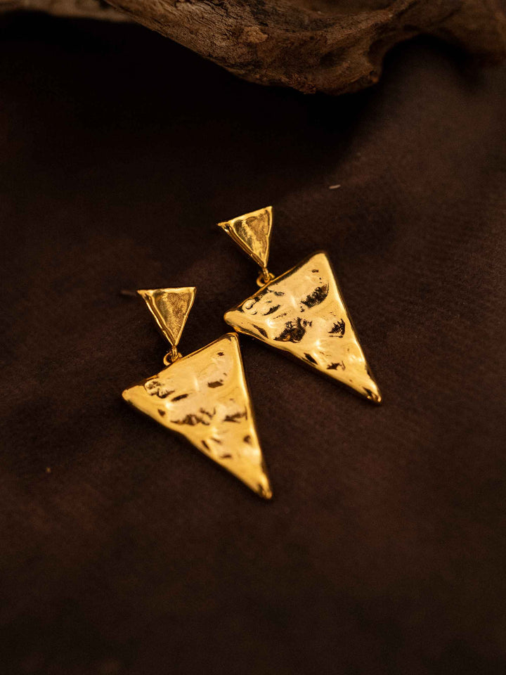 A triangular gold earring