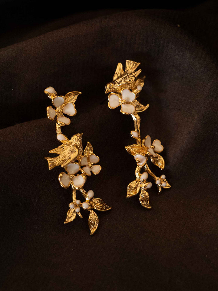 One long gold floral earring