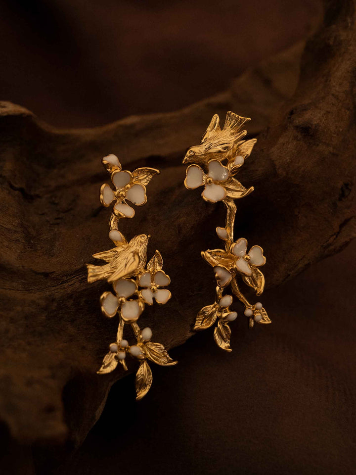 One long gold floral earring