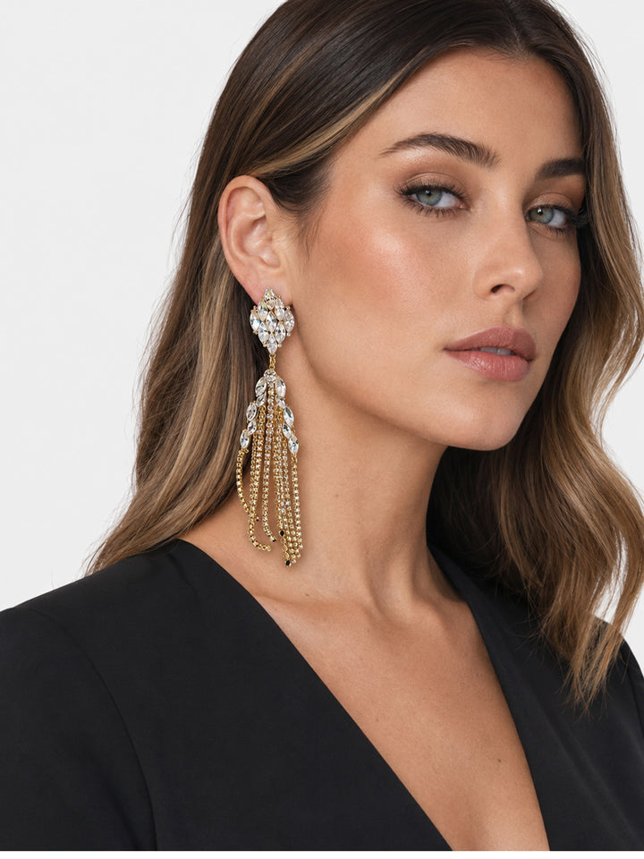 Long crystal statement earrings worn with evening look