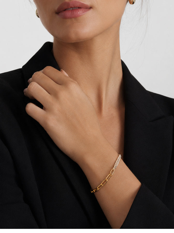 Mixed-metal chain bracelet worn with black outfit