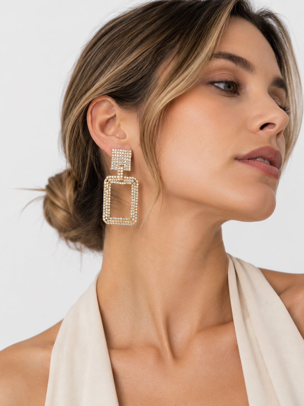 Long rectangle crystal earrings worn with white outfit