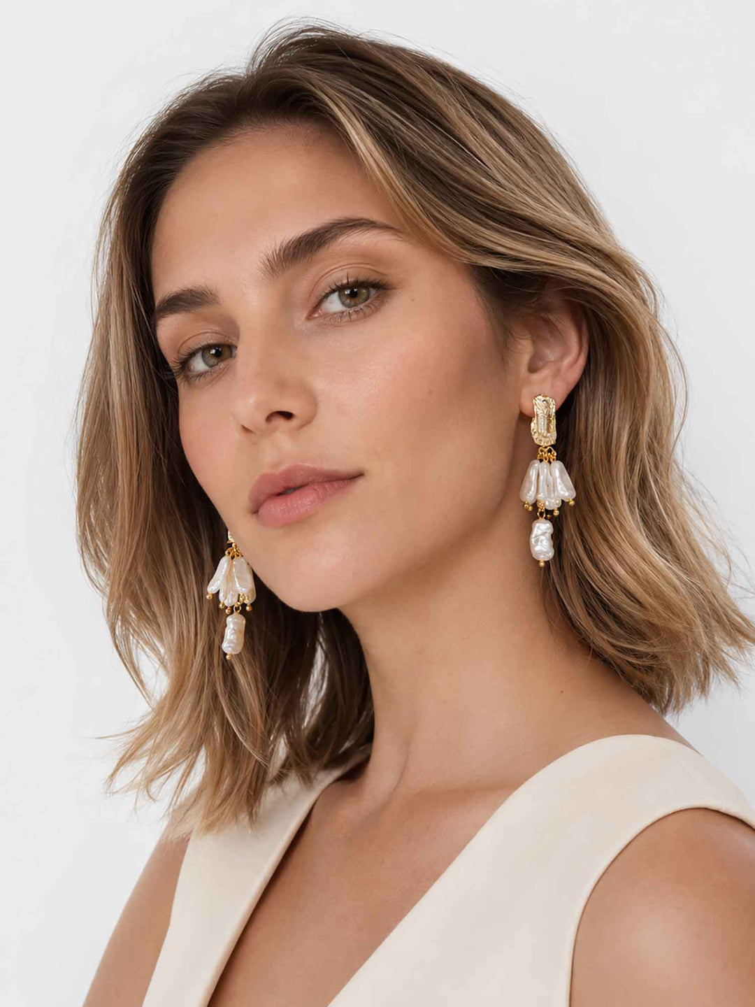 Side view of model wearing Samira baroque pearl drop earrings