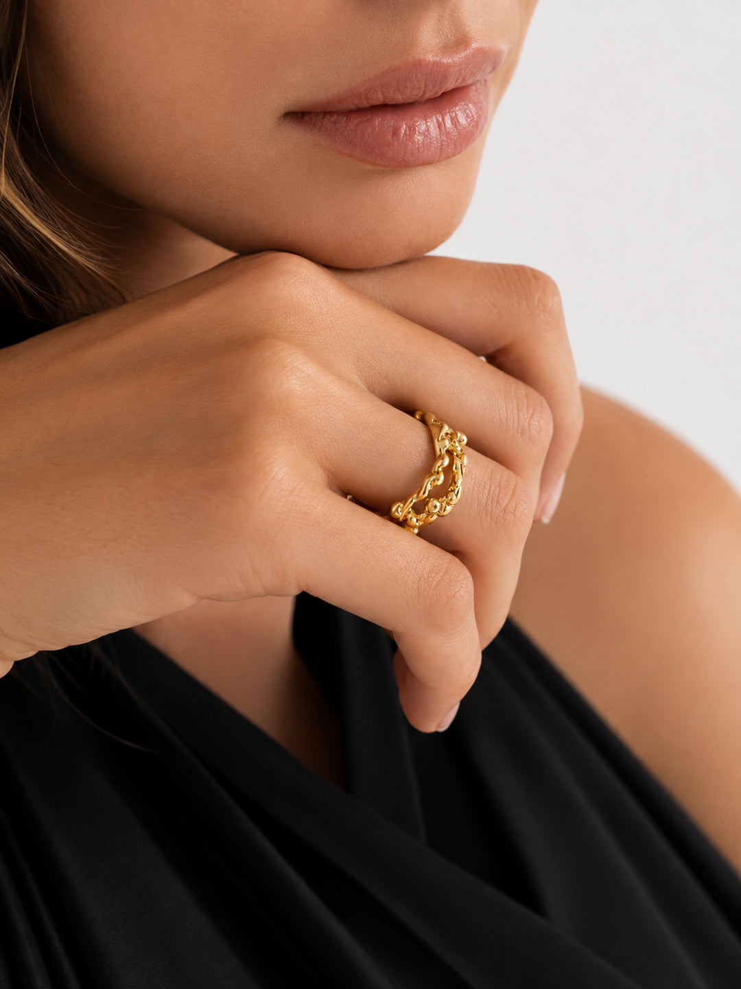 Gold-plated wave ring worn with black outfit