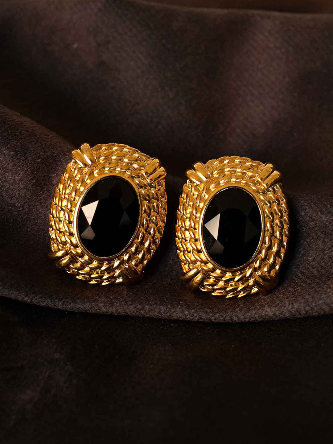 Atenea black glass statement earrings styled on dark fabric