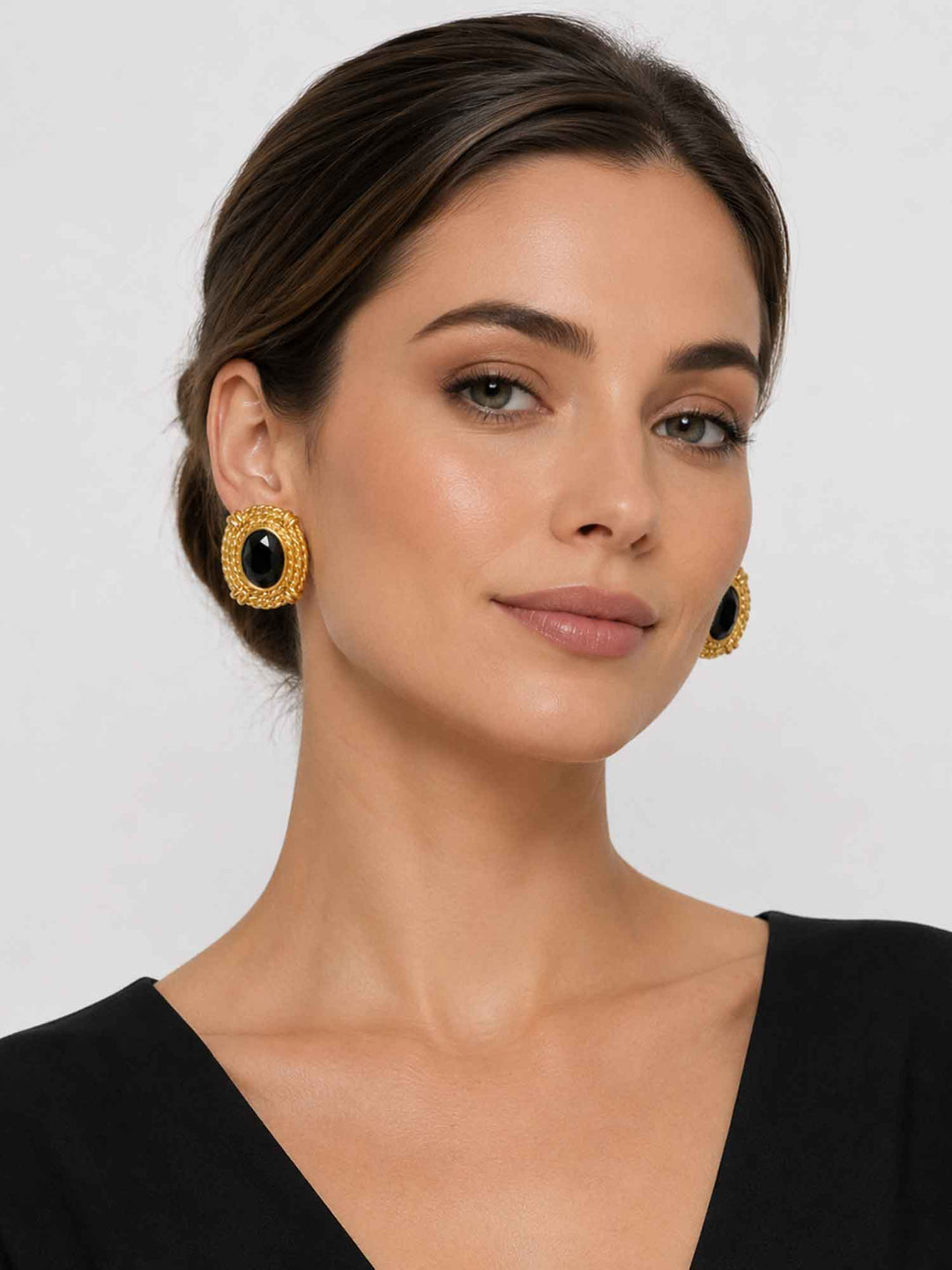 Model wearing black glass statement earrings with a polished evening look
