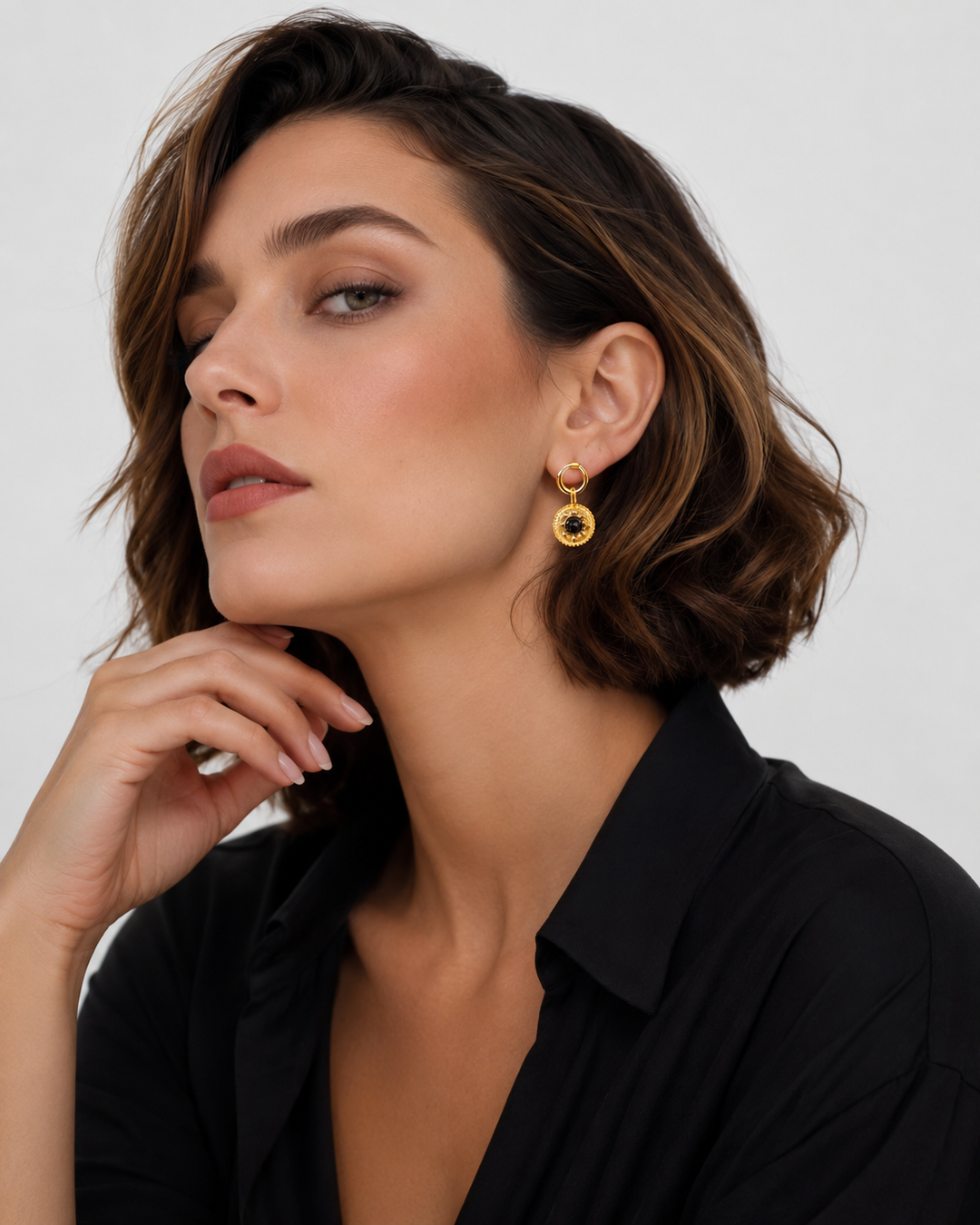 Model wearing Celandine reversible black agate gold drop earrings with evening styling