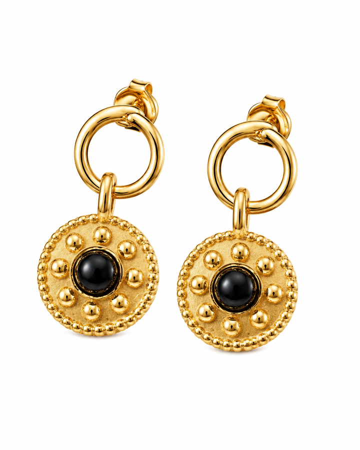 Detail view of Celandine reversible black agate gold drop earrings showing two-tone pendants