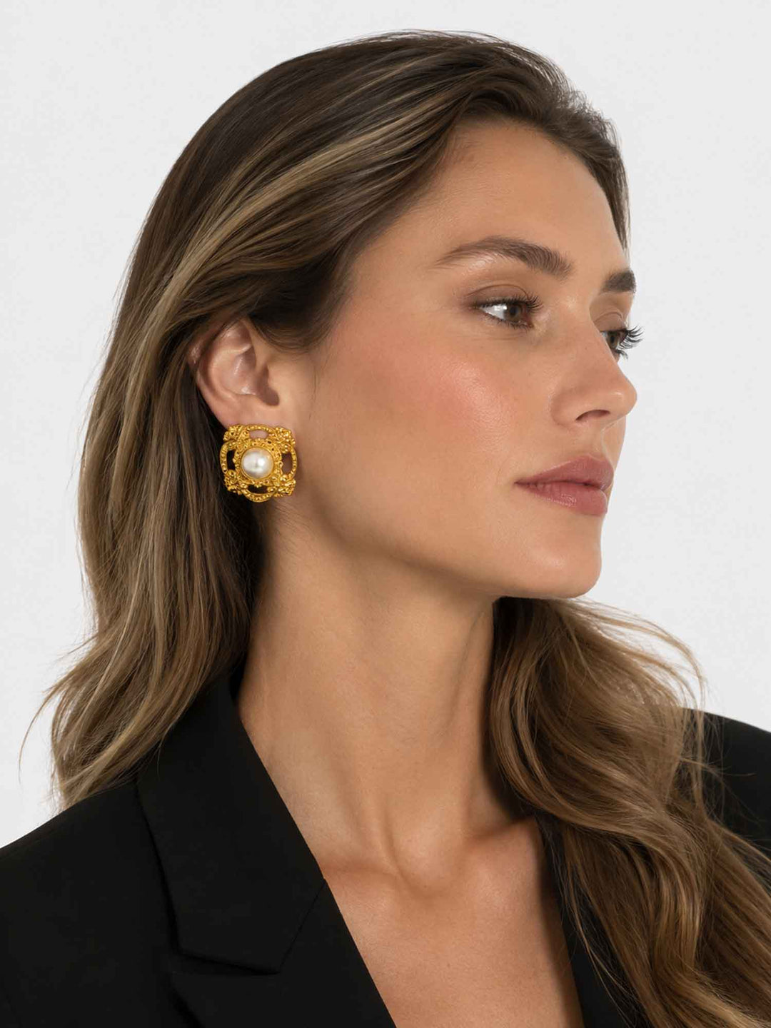 Side view of model wearing classic acrylic pearl gold stud earrings
