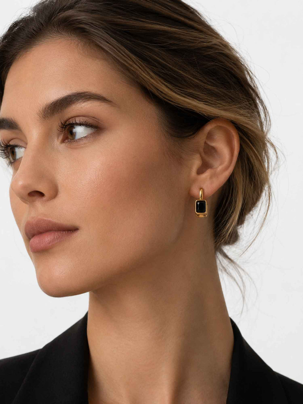 Model wearing Clelia black cubic zirconia hoop earrings with elegant styling