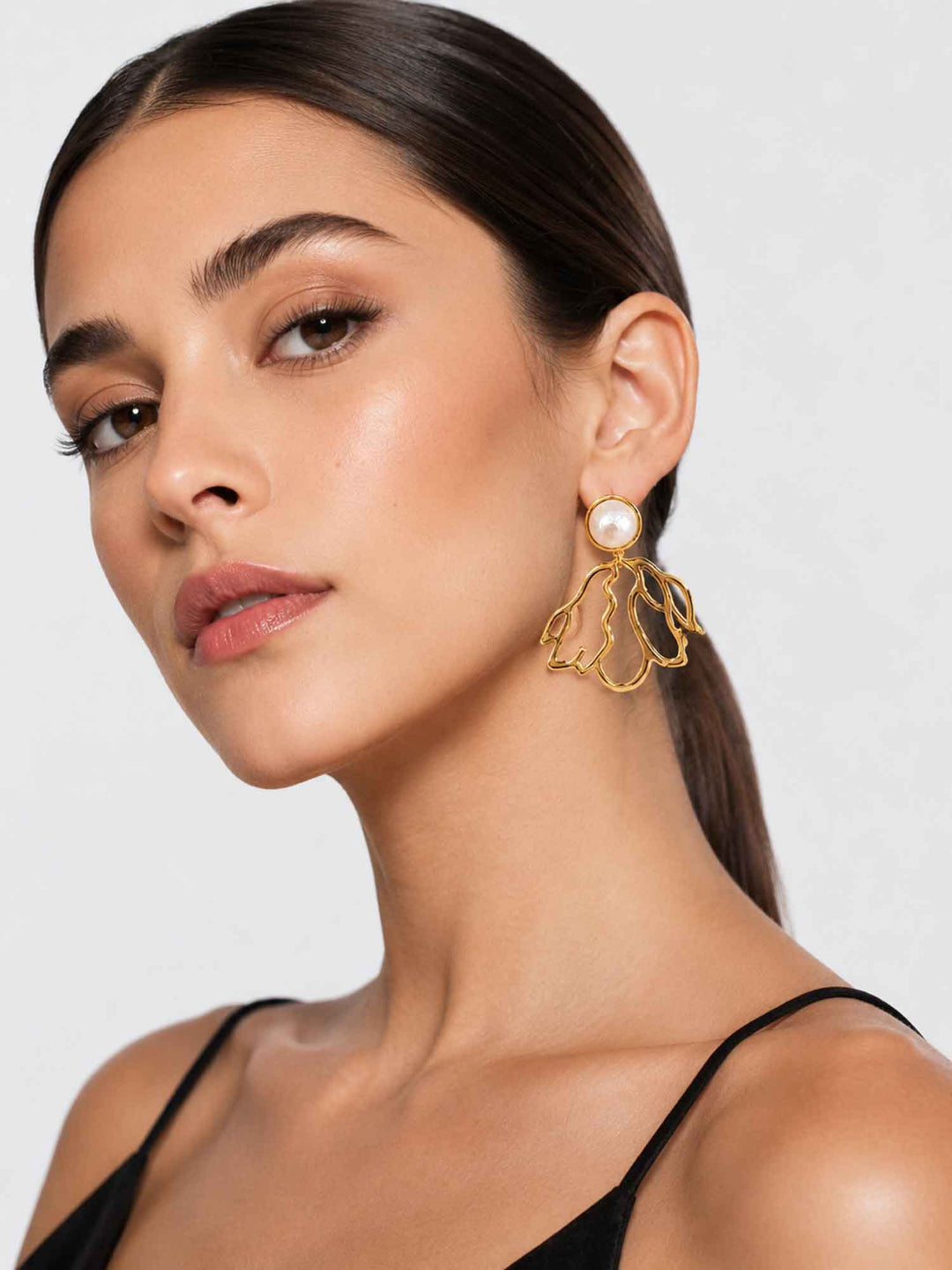 Model wearing Dancer cotton pearl gold drop earrings with elegant styling