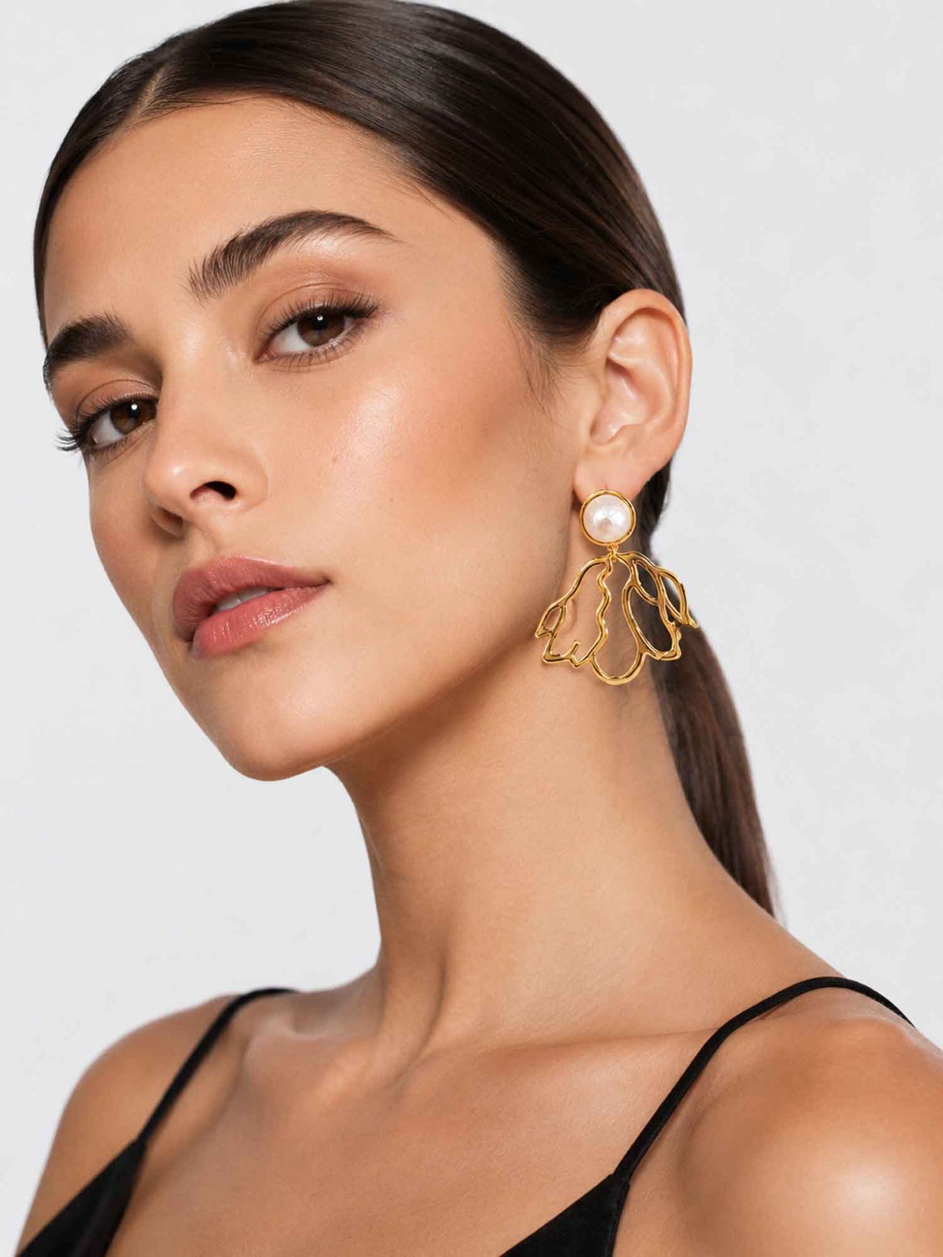 Model wearing Dancer cotton pearl gold drop earrings with elegant styling