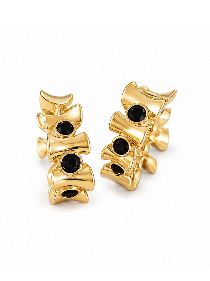 Pair of Eudora black onyx gold huggie hoop earrings on white background
