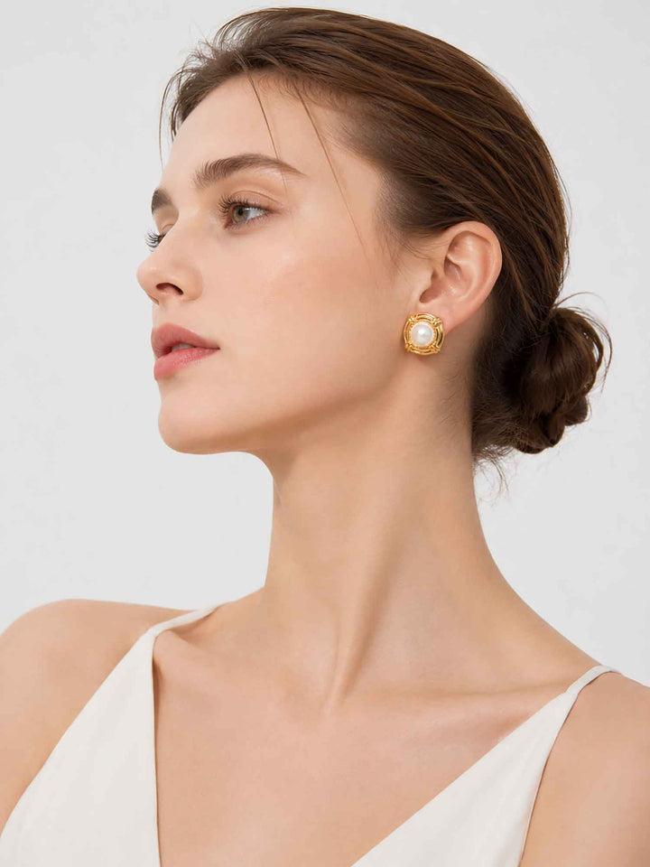 Model wearing gold pearl stud earrings for bridal and occasion styling