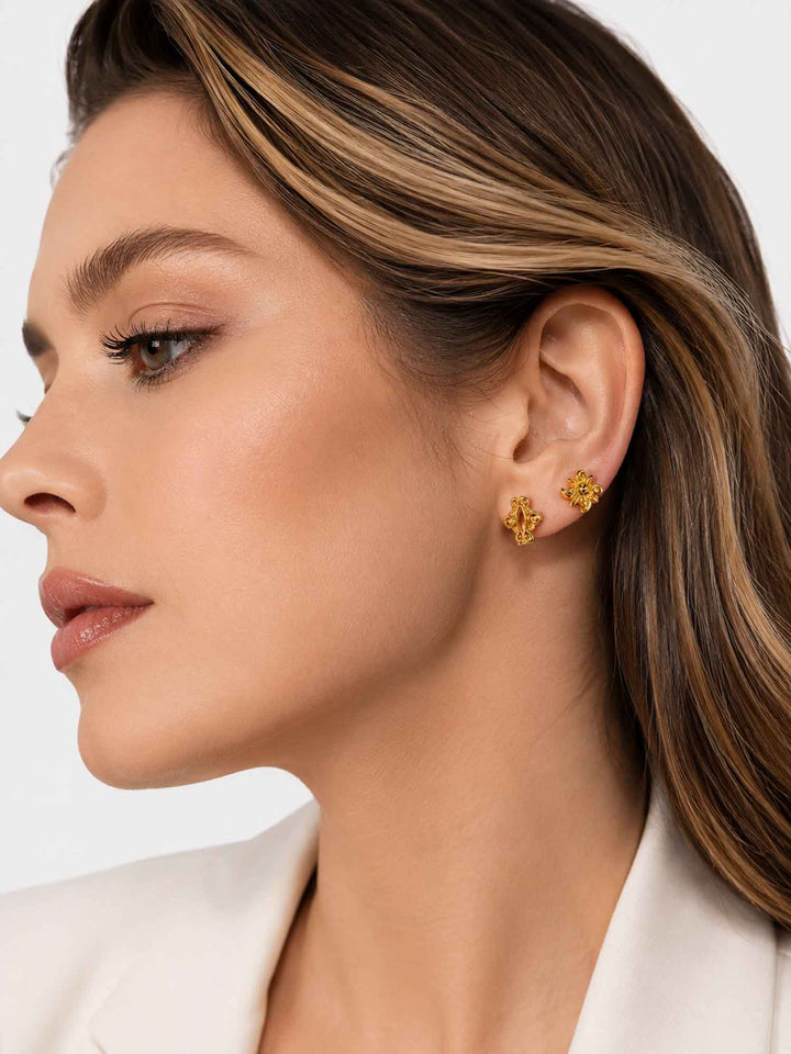 Side view of model wearing Iris floral gold mini hoop earring set