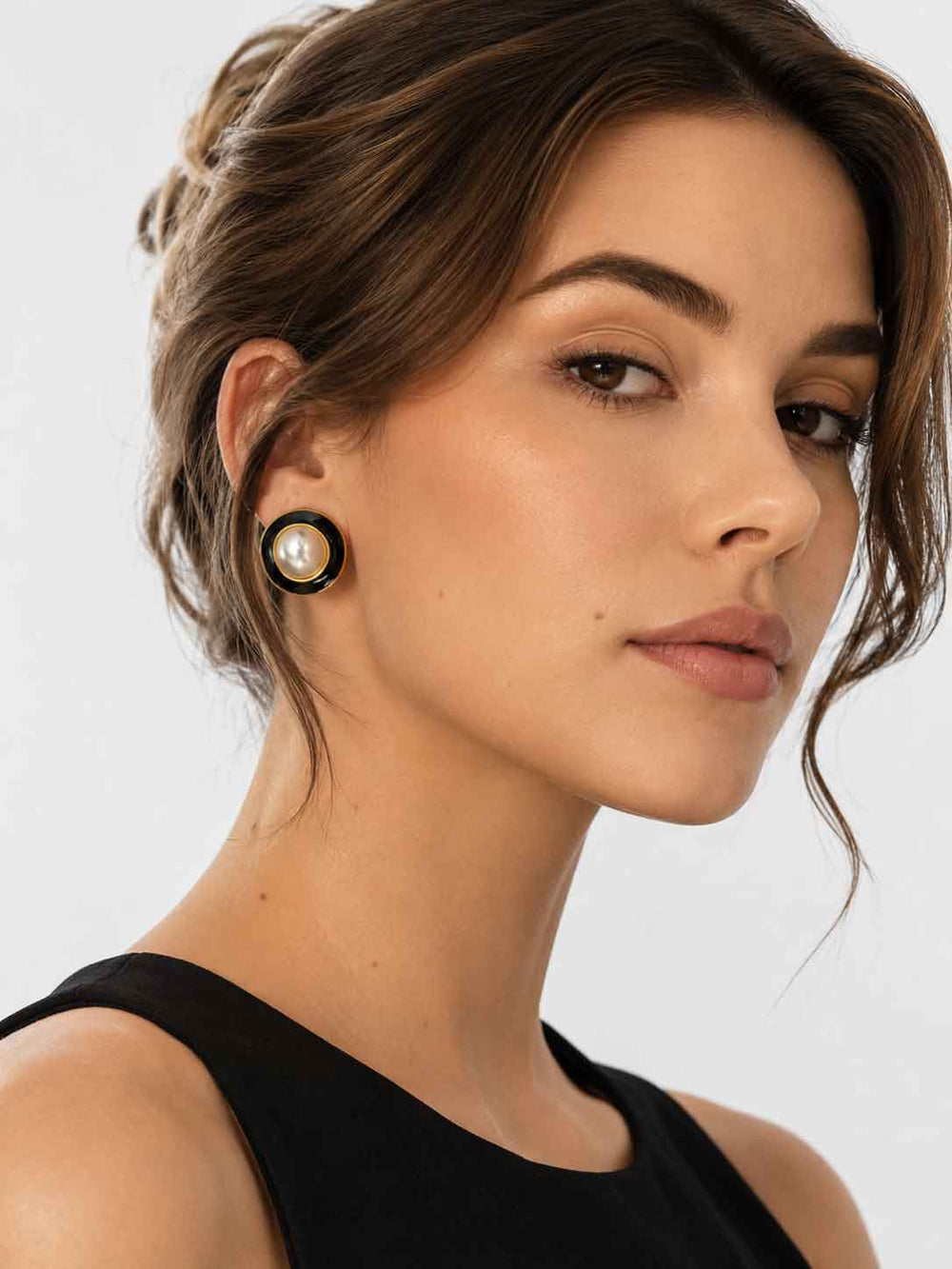 Model wearing Kason black enamel pearl stud earrings with black outfit