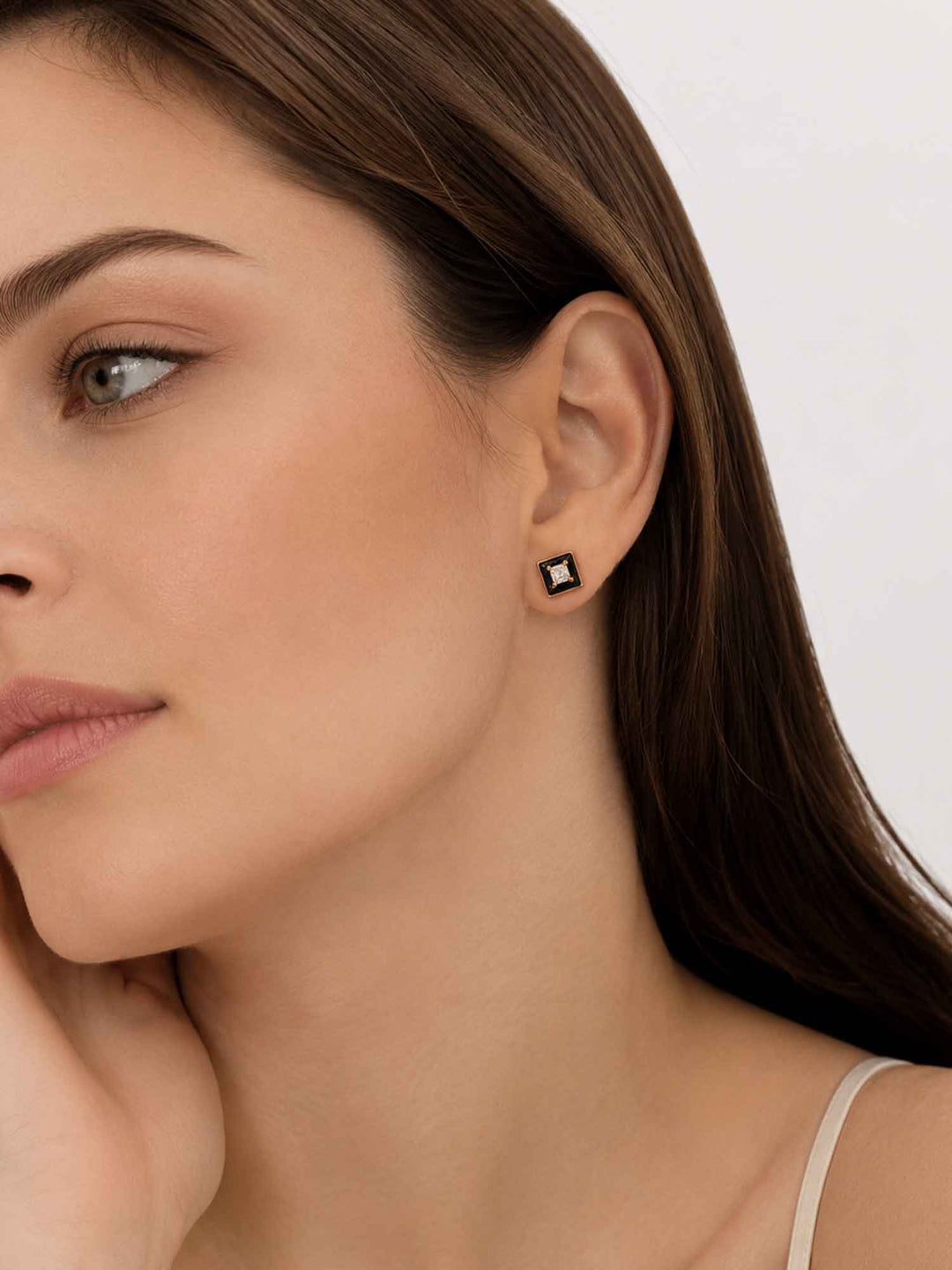 Close-up view of model wearing Leticia black enamel cubic zirconia stud earrings