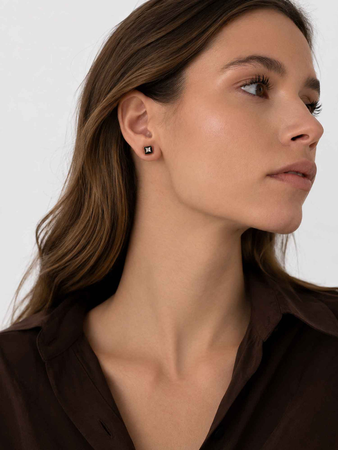 Side view of model wearing Leticia black enamel cubic zirconia stud earrings
